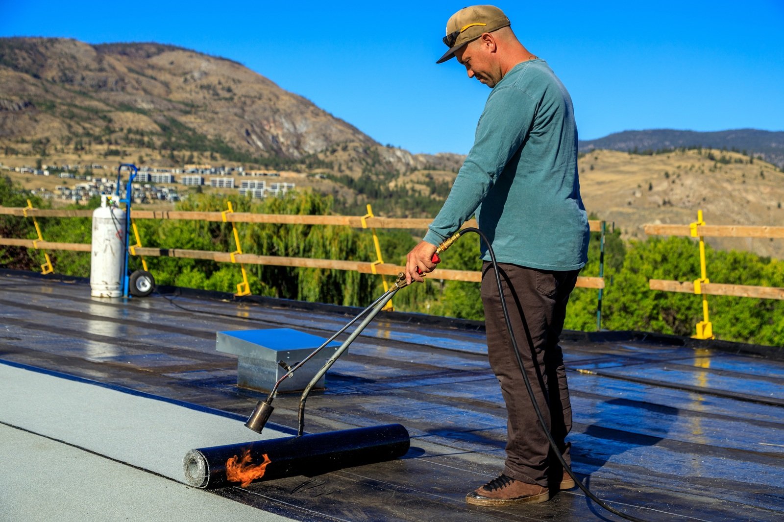 A,Roofer,Torches,A,Membrane,Layer,On,A,Flat,Roof